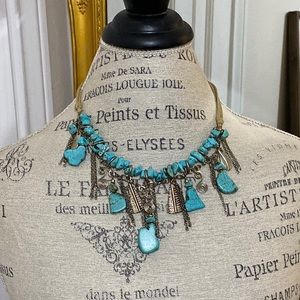 Turquoise and silver toned necklace.